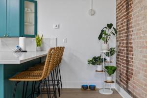 a kitchen with green cabinets and a counter with stools at City View Loft in Saint Joseph