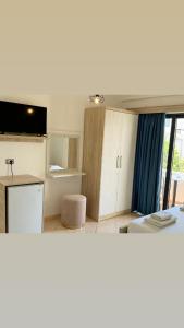 a room with a kitchen with a counter top and a room with at Villa White in Ksamil