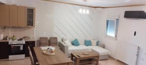 a living room with a couch and a table at MV LUX Apartment in Alexandroupoli