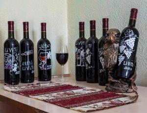 a group of wine bottles and a wine glass at LiViTi in Areni