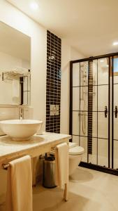 a bathroom with a sink and a toilet at Villa Lukka in Cıralı