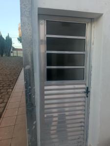 uma porta de garagem com uma janela do lado de um edifício em Assel Pousada Botanico em Curitiba