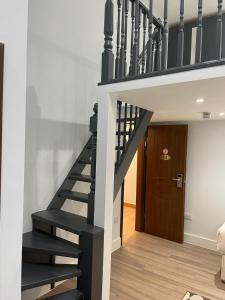 a staircase in a house with a black stair case at MSK Superior in London