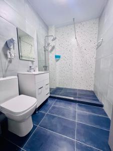 a bathroom with a toilet and a sink and a shower at Sea Panorama Apartments & Free Parking in Năvodari +58 photos