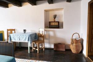 a dining room with a table and a chair and a microwave at Casa Klein- întreaga locație in Meşendorf
