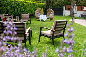 a group of chairs and a table in the grass at Sechex Nous in Margencel