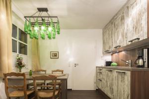 a kitchen with a dining table and a chandelier at Jovles Beisken GmbH in Münster