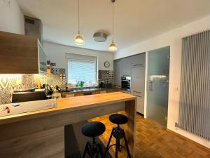 a kitchen with a counter and two stools at Arnold's Nest in Kotlje