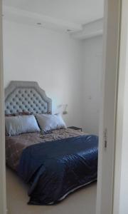 a bedroom with a large bed with a blue blanket at Kariat Cabo resort in M'diq +18 photos