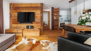 a living room with a television and a table at Chalet Luna in Zermatt