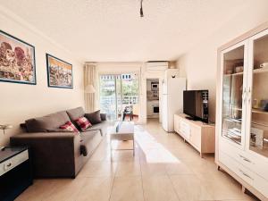 a living room with a couch and a tv at COSTA DAURADA APARTAMENTS - Alboran II in Salou +15 photos