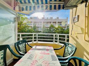 a table and chairs on a balcony with a view of a building at COSTA DAURADA APARTAMENTS - Alboran II in Salou