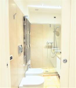 a bathroom with a toilet and a glass shower at Stylish apartment 100 meters from San Marco square in Venice
