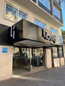 a store with a sign on the front of a building at Líbere Madrid Chamberí in Madrid