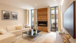 ein Wohnzimmer mit Sofa und Kamin in der Unterkunft L'Écrin Alpin - Centre historique - Haut standing in Chambéry