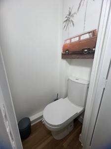 a bathroom with a toilet and a picture of a van at Modern Renovated Apartment -15 min Orly airport in Viry-Châtillon +15 photos