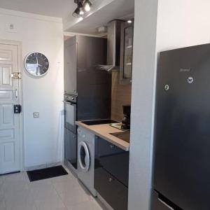 a kitchen with a refrigerator and a washer and dryer at Appartement port Nautic 5 Empuria in Empuriabrava