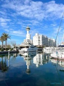 a marina with boats and a lighthouse in the water at Appartement port Nautic 5 Empuria in Empuriabrava