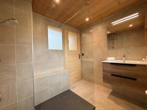 a bathroom with a shower and a sink at Chalet l'Abériot in Montriond +46 photos