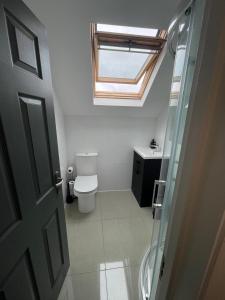 a bathroom with a toilet and a skylight at 1 Bedroom Flat in Bedford in Bedford
