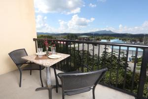 a table and chairs on a balcony with a view at Mountain View Condo 1205 by Eden Crest in Pigeon Forge