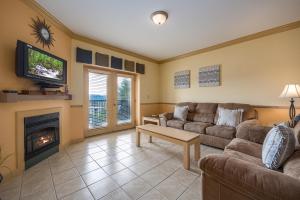 a living room with a couch and a fireplace at Mountain View Condo 1205 by Eden Crest in Pigeon Forge