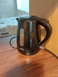 a black coffee cup sitting on a table at Apartment with sauna in Harjavalta, free WIFI in Harjavalta +8 photos