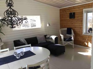 a living room with a couch and a table at Loberget Oviken in Oviken