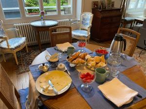 a wooden table with food on top of it at AQUARELLE in Avranches