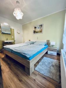 a bedroom with a bed with a blue comforter at Ferienwohnung Sonneck in Altenahr