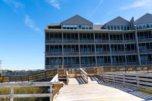 a building on a boardwalk in front of a building at Sea Watch Inn at the Landing in Myrtle Beach