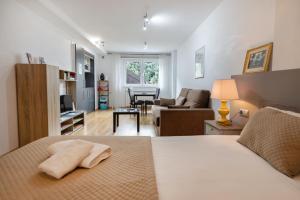 a bedroom with a bed and a living room at Charming Studio with Mountain View in Arinsal - 40m² in Arinsal