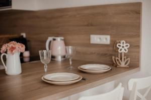 a table with plates and glasses on a wooden counter at Studio cocoon hypercentre Carré d'or de Strasbourg in Strasbourg