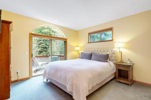 a bedroom with a large bed and a window at Tahoe Donner Snow Globe in Truckee