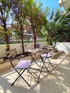 deux chaises et une table sur une terrasse avec des arbres dans l'établissement Casa Vacanze 'La Scogliera', à Bisceglie