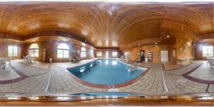 a large indoor swimming pool with a wooden ceiling at Comfort Inn Van Wert in Van Wert