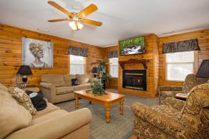 a living room filled with furniture and a fireplace at Briarstone Lodge Condo 13C in Pigeon Forge
