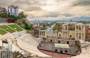 an amphitheater with a city in the background at City Center Studio Apartments in Plovdiv