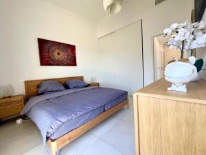 a bedroom with a bed and a vase of flowers at Panoramic Sea View Appartment Blue Pearl in Nice +8 photos