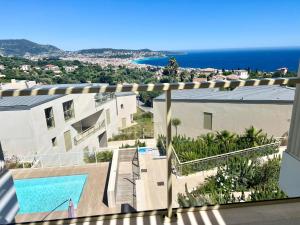 a view from the balcony of a house with a swimming pool at Panoramic Sea View Appartment Blue Pearl in Nice