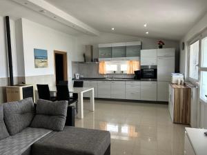 a kitchen with a couch and a table in a room at Apartments Eržen in Medulin