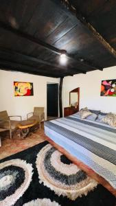 a bedroom with a bed with a rug on the floor at Minca cabaña la roca in Santa Marta