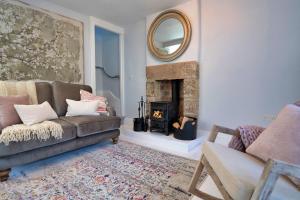 a living room with a couch and a fireplace at Finest Retreats - Sisu Bakewell, Limestones Cottage in Bakewell