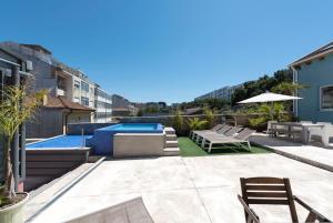 a backyard with a swimming pool and patio furniture at Fred's House Asprela in Porto