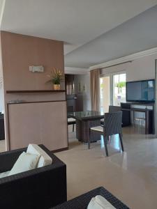 a living room with a couch and a table at Aktaion apartments in Artemísion