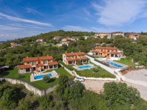 an aerial view of a house on a hill at 2 bedrooms house with city view shared pool and enclosed garden at Ripenda Kras 4 km away from the beach C in Ripenda Kras
