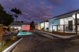 a house with a swimming pool in front of it at Domaine de Sainval in Sainte-Rose