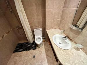 a bathroom with a toilet and a sink at Julia Vigo Panorama apartments in Nesebar