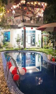 a swimming pool with red and white balls in it at Homestay Happy Home Sóc Sơn in Hanoi