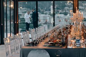 a long table with glasses on it in a building at Brim Hotel in Tbilisi City
